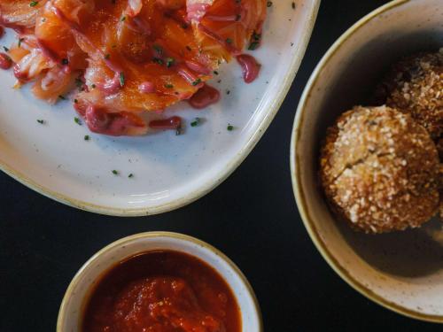 a table with two plates of food and a bowl of sauce at TRIBE Lyon Croix Rousse in Lyon