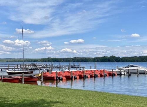 a group of boats docked at a dock on a lake at Moderne Doppelhaushälfte mit 3 SZ in der Nähe vom Scharmützelsee-seperat&naturnah in Wendisch Rietz