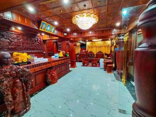 a hotel lobby with a bar and a chandelier at HONG PEP HOTEL in Battambang