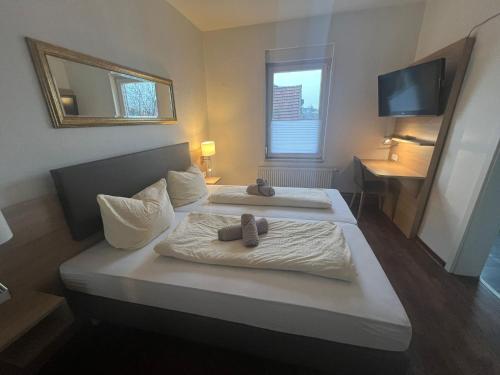 2 Betten in einem Hotelzimmer mit Handtüchern darauf in der Unterkunft Tilla's Hof in Hamm