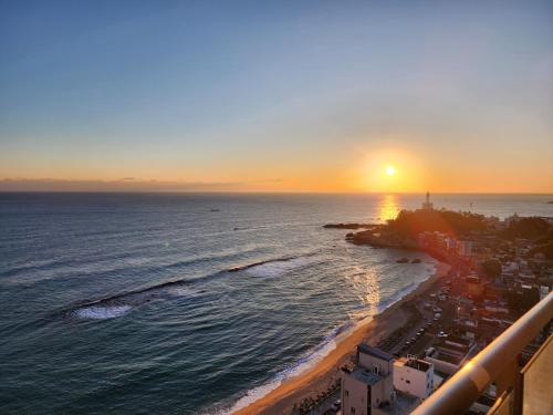 an aerial view of the beach at sunset at Sokcho Summitbay 1708 "Ocean View" in Sokcho