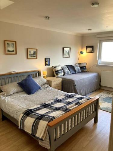 a bedroom with two beds and a window at Bright central large cosy flat in Fife