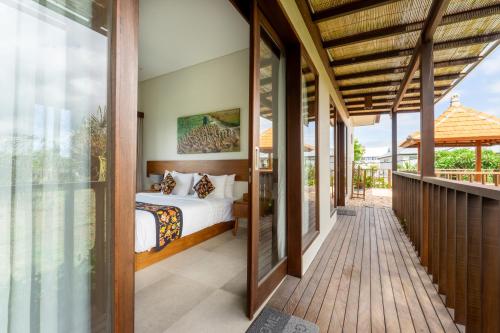 チャングーにあるAngan-Angan Villasのヴィラ内のベッドルーム(バルコニーにベッド付)