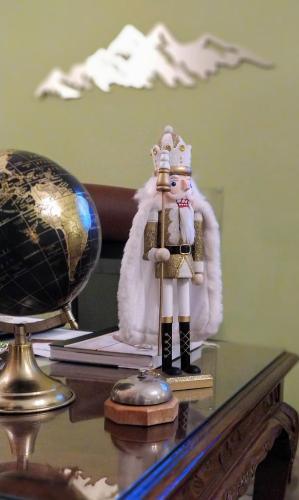 a figurine of a king and a globe on a table at Olympus View Rooms Sauna & Spa in Litochoro