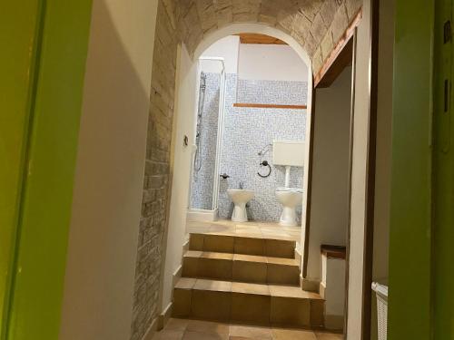 a hallway with a bathroom with a toilet and a sink at CasaNella in Lanciano