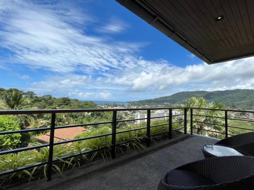 a balcony with a view of the mountains at Villa Tantawan Resort - Private Pool Villas in Kamala Beach