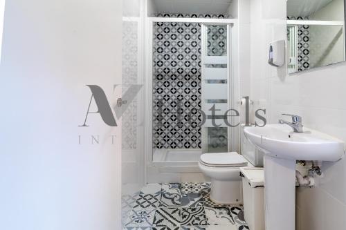 a bathroom with a toilet and a sink and a shower at AYZ Ulises - Auto check-in property in Madrid