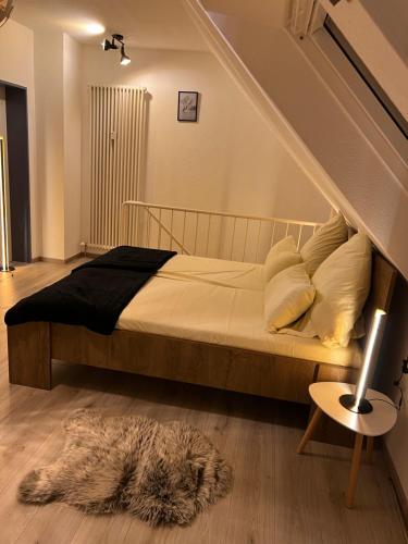 1 dormitorio con cama y alfombra en el suelo en Top of Hostel & Serviced Aparts Deluxe Maisonette-Apart Fürth, en Fürth