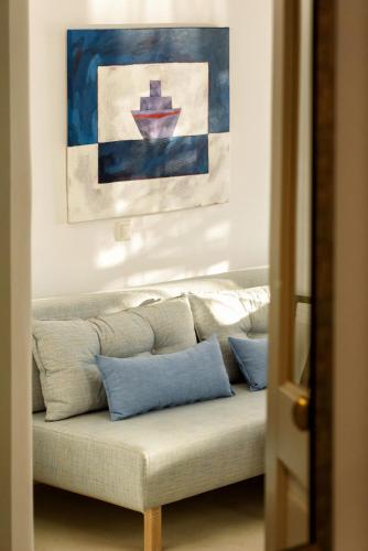 a couch with blue pillows in a living room at Hotel Senia - Onar Hotels Collection in Naousa