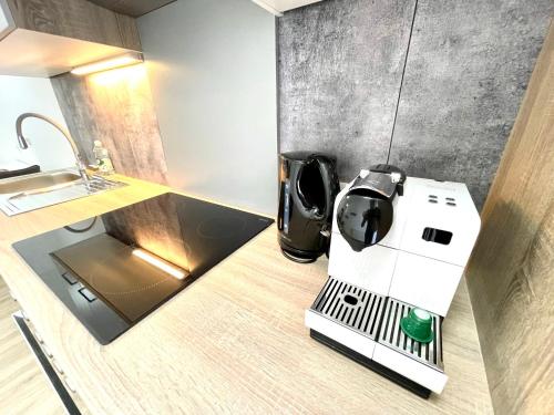 a kitchen with a coffee machine on a counter at Pension Maier in Villach