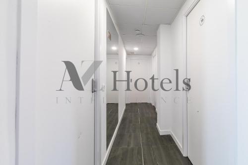 a hallway with a hotel sign on the wall at AYZ Ulises - Auto check-in property in Madrid