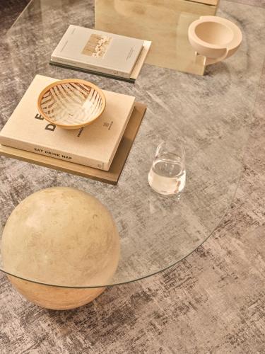 a glass table with a book and a bowl on it at The Marloes in London
