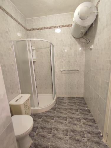 a bathroom with a shower and a toilet and a sink at Dolphin Court 3-Bedroom Sea View Apartment in Marsaskala, Malta in Marsaskala