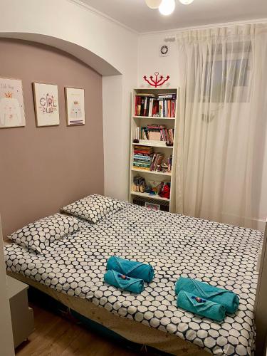 a bedroom with a bed with two blue bags on it at Scandinavian Home in Bucharest City Center in Bucharest
