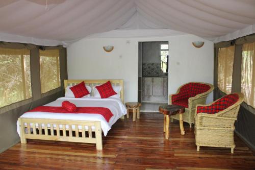 Ένα ή περισσότερα κρεβάτια σε δωμάτιο στο Mara Empiris Safari Camp