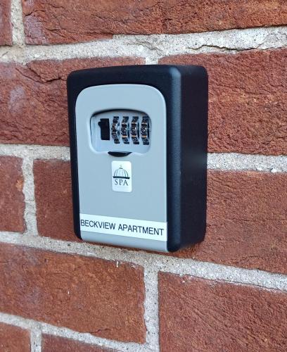 a black electrical outlet on a brick wall at Beckview En-Suite in Scalby