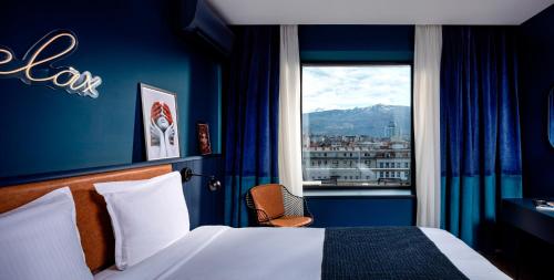 a hotel room with a bed and a window at Rila Hotel Sofia in Sofia