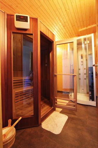 a wooden room with a glass door and a balcony at Felső Fogadó in Felsőtold