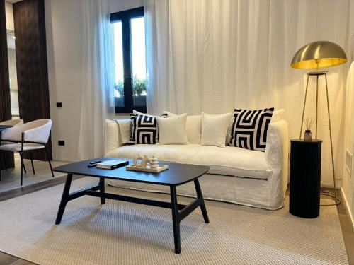 a living room with a couch and a coffee table at Ostia Holiday Kama Wellness Home in Lido di Ostia