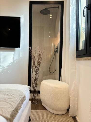 a bedroom with a bed and a shower with a stool at Ostia Holiday Kama Wellness Home in Lido di Ostia