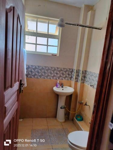 a bathroom with a sink and a toilet at Gulf breeze heritage in Ruiru