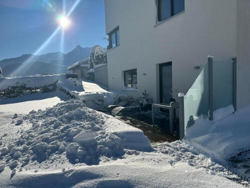 a pile of snow in front of a building at Ferienwohnung Saxenhammer in Vandans