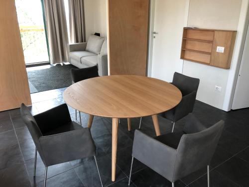 a dining room with a wooden table and chairs at Agriturismo Voeuja Lago Maggiore in Luino