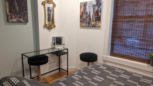 a room with a glass table and two stools at CENTRAL PARK EAST and MUSEUMS in New York