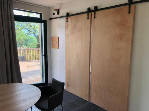 a sliding door in a room with a table and a window at Agriturismo Voeuja Lago Maggiore in Luino