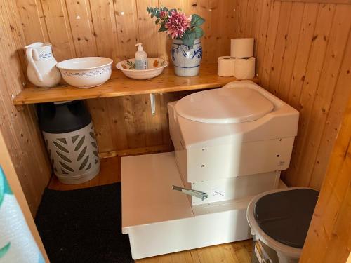 a kitchen with a sewing machine on a shelf at Syndin seter in Ryfoss
