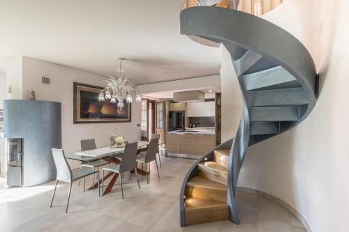 a spiral staircase in a dining room with a dining table at Charming Apartment La Pollona in Torino