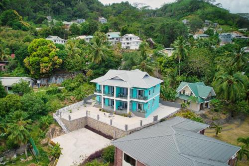 an aerial view of a house with a blue roof at Sunset Haven Villa in Beau Vallon