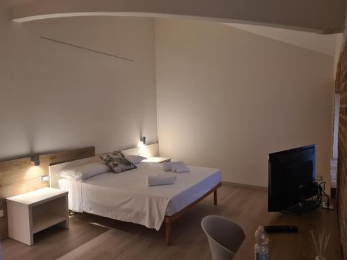 a bedroom with a bed and a flat screen tv at Simona Rooms in Portocannone