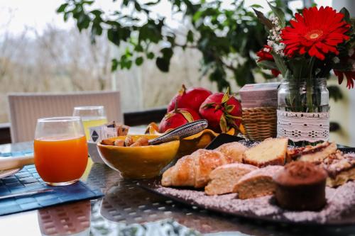 a table with a plate of food and a glass of orange juice at Hotel Villa Rizzo Resort and Spa in San Cipriano Picentino