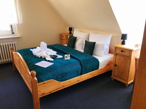 a bedroom with a bed with a doll on it at Hotel Elisabeth Ilse in Braunlage