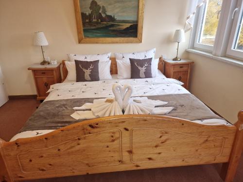 a bedroom with a large wooden bed with flowers on it at Hotel Elisabeth Ilse in Braunlage
