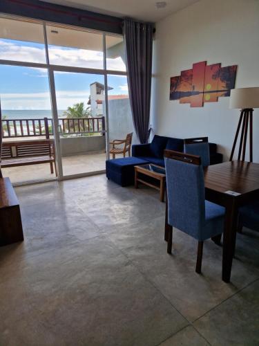 a living room with a view of the ocean at Chill Bay Weligama in Weligama