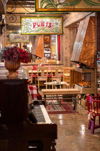 a restaurant with a piano and tables and chairs at Hotel Aran La Abuela in Vielha