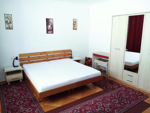 a bedroom with a bed and a large mirror at Apartment Beatris in Jezersko