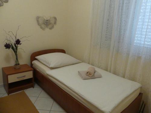 a bedroom with two twin beds with a butterfly on the wall at Villa Skoric in Orebić