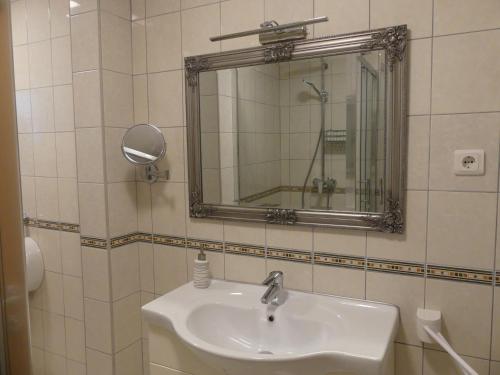 a bathroom with a sink and a mirror at Villa Skoric in Orebić