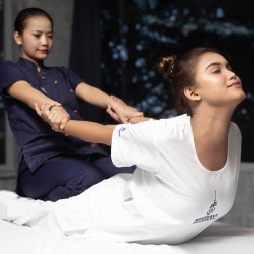 a woman is getting her hair cut by another woman at Novotel Chennai Sipcot in Chennai