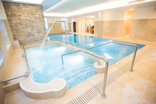 a large swimming pool in a building at Galway Bay Hotel Conference & Leisure Centre in Galway