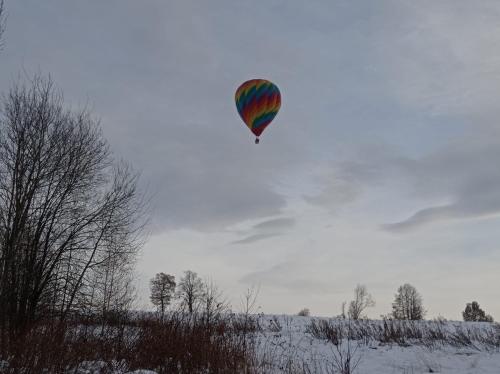 a kite flying in the sky over a snow covered field at Róże i Jabłonie Agroturystyka in Gryfów Śląski