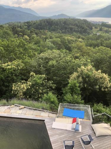 a view of a deck with a pool and chairs at Agriturismo Voeuja Lago Maggiore in Luino