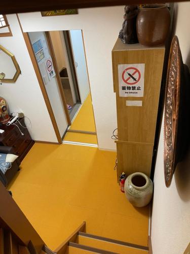 a hallway with a box and stairs in a room at AnNam Stay Osaka Airport in Toyonaka