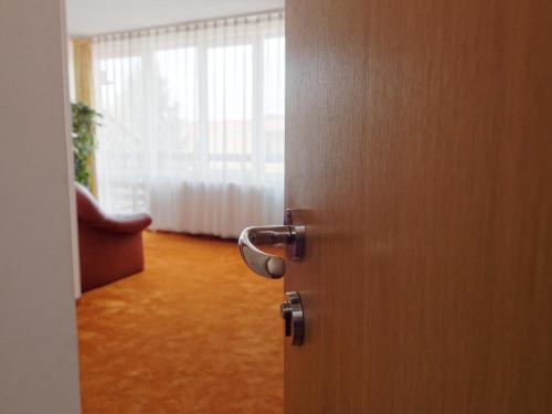 an open door to a room with a window at Hotel Oasis in Braşov