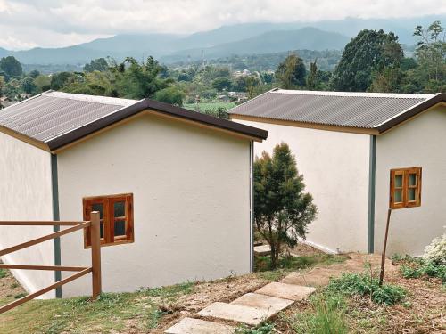 a white house with solar panels on top of it at Monko Mini room in Pai