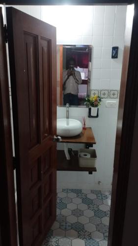 a bathroom with a sink and a person taking a picture at Mammamia CasaHotel in Duitama