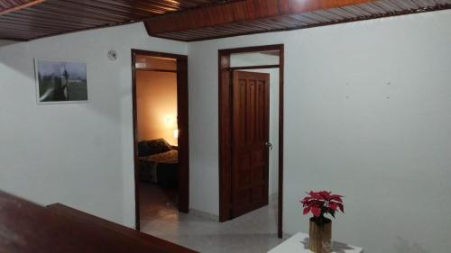 a room with a door leading to a bedroom at Mammamia CasaHotel in Duitama